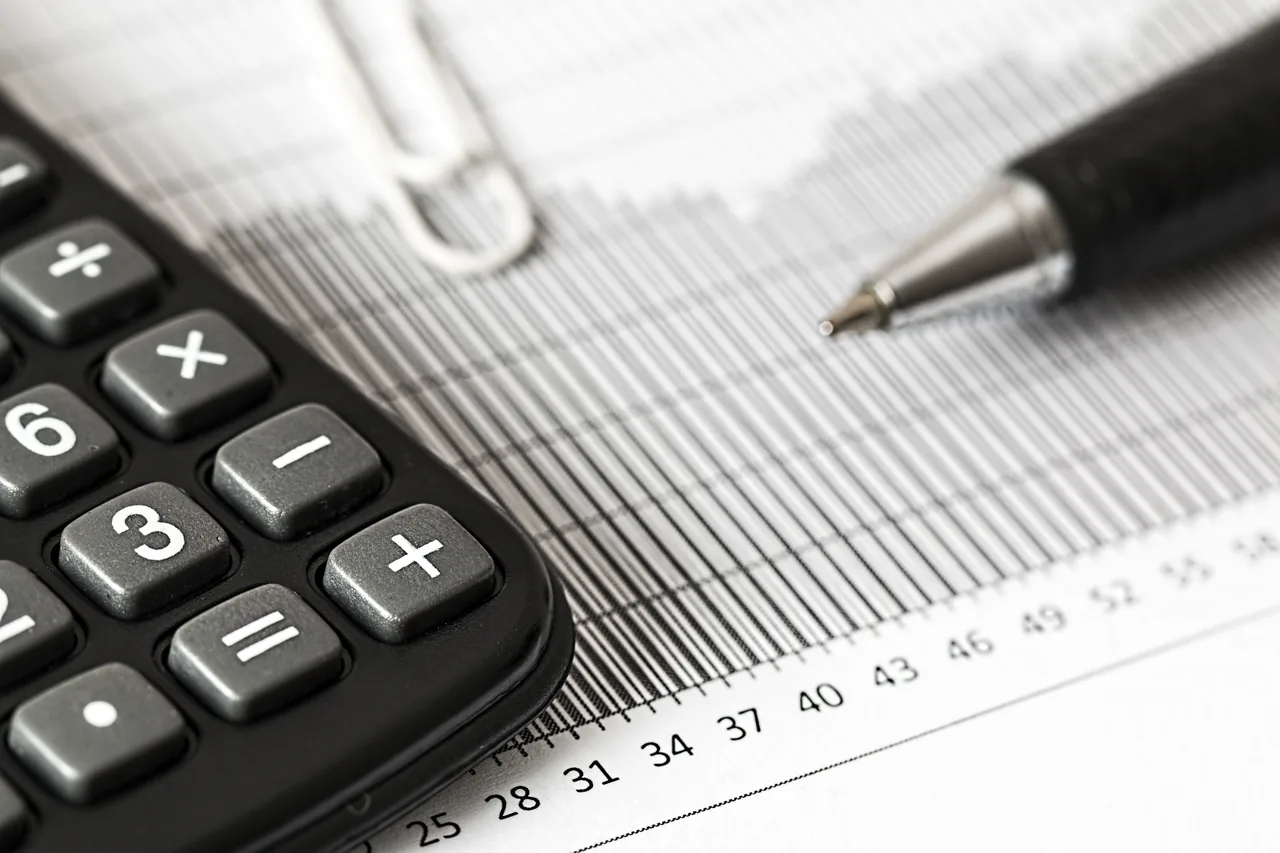 Calculator and pen on a page of financial figures